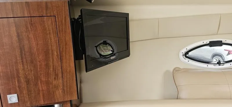 Slide: The Image of Interior of 2015 Monterey 295 Sport Yacht with TV and wooden cabinet. - 15