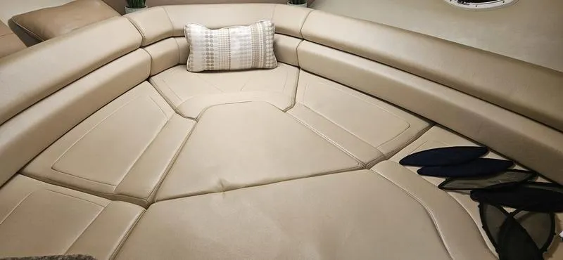 Slide: The Image of 2015 Monterey 295 Sport Yacht interior with beige seating and decorative pillow. - 16