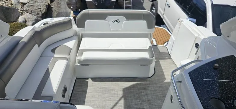 Slide: The Image of 2015 Monterey 295 Sport Yacht interior with white seating and modern design. - 17