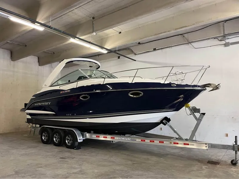 Slide: The Image of 2015 Monterey 295 Sport Yacht on trailer in indoor storage facility. - 2