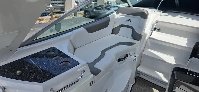 Slide: The Image of 2015 Monterey 295 Sport Yacht interior with white seating and black countertop. - 20