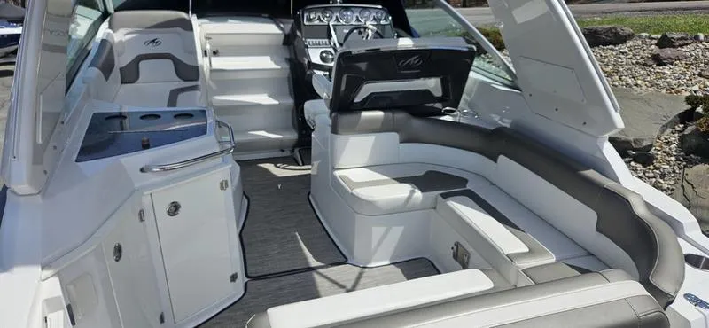 Slide: The Image of 2015 Monterey 295 Sport Yacht interior with sleek seating and modern dashboard. - 22