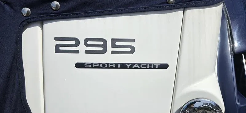 Slide: The Image of 2015 Monterey 295 Sport Yacht emblem on white surface. - 23