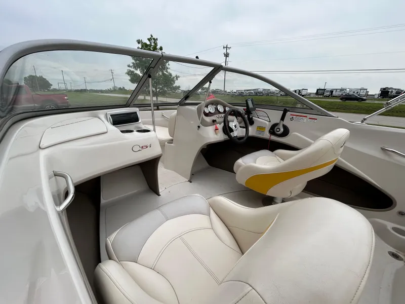 Slide: The Image of 2010 Tahoe Q5SI boat interior with white and yellow seating, steering wheel, and dashboard controls. - 11