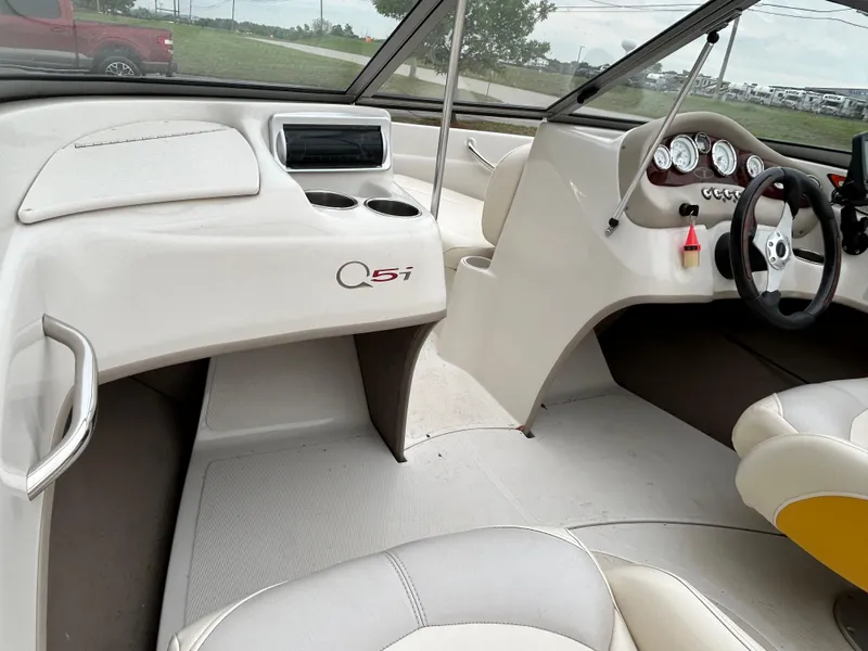Slide: The Image of Interior of a 2010 Tahoe Q5SI boat, featuring steering wheel and dashboard controls. - 14