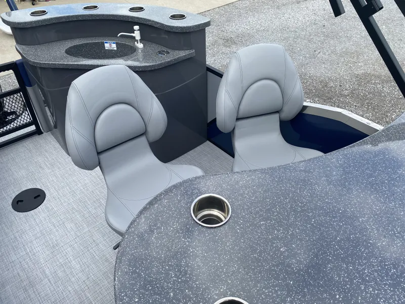 Slide: The Image of 2025 Berkshire 23E STS boat interior with gray seating, speckled countertop, and built-in sink. - 15
