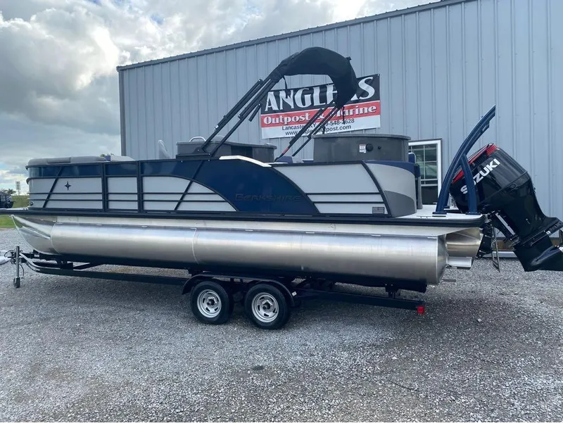 Slide: The Image of 2025 Berkshire 23E STS pontoon boat with Suzuki outboard motor on trailer. - 20