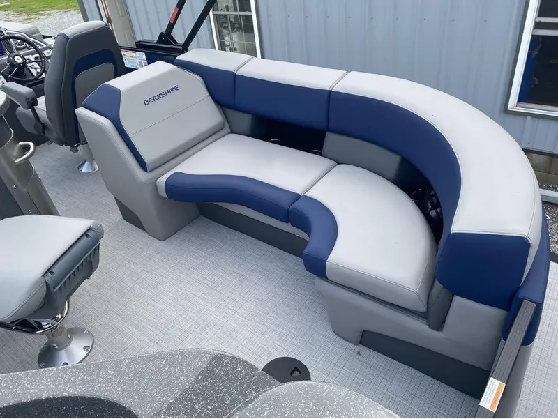 Slide: The Image of 2025 Berkshire 23E STS pontoon boat interior with blue and gray seating arrangement. - 21