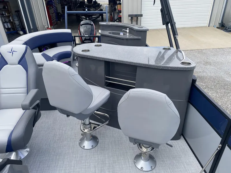Slide: The Image of 2025 Berkshire 23E STS boat interior with modern seating and sleek bar area. - 5