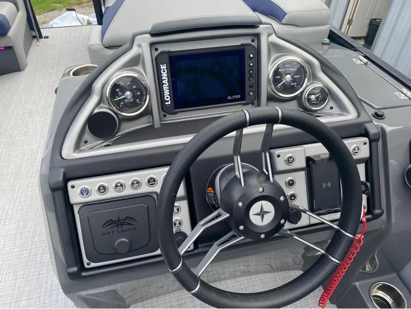 Slide: The Image of Steering console of 2025 Berkshire 23E STS boat with Lowrance display and controls. - 8