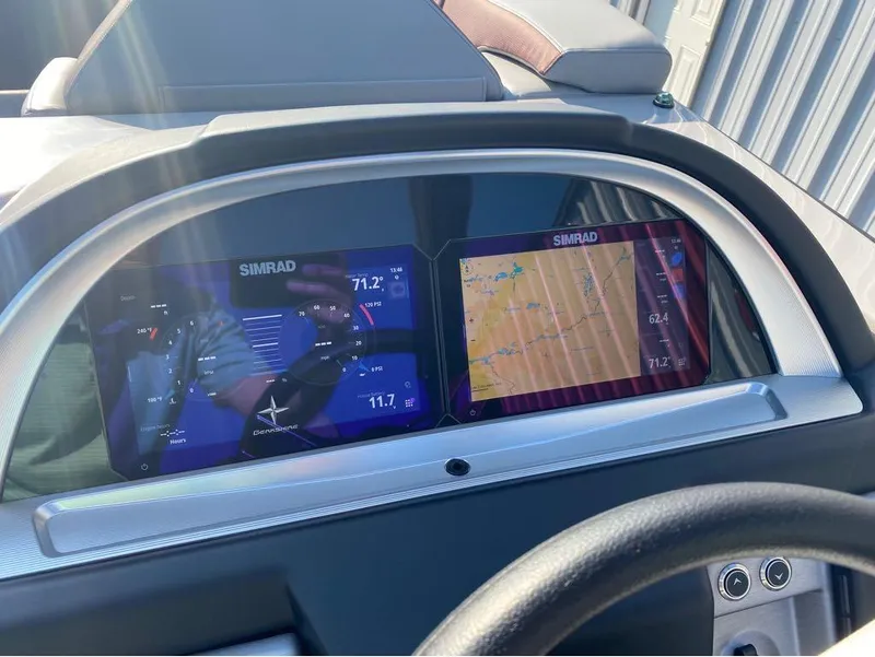 Slide: The Image of Dashboard of 2025 Berkshire 23UL STS with dual Simrad displays showing navigation and engine data. - 11