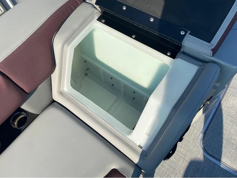 Slide: The Image of Open storage compartment on 2025 Berkshire 23UL STS boat with cushioned seating. - 15