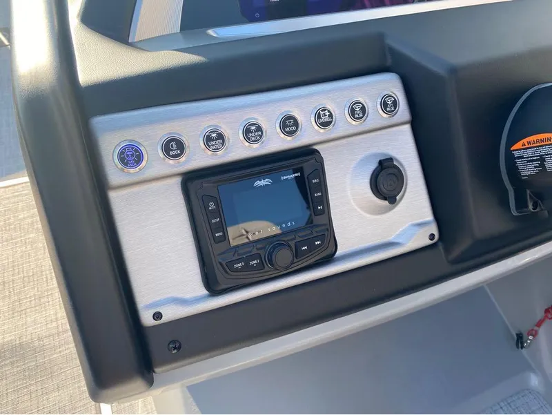 Slide: The Image of Control panel of 2025 Berkshire 23UL STS boat with buttons and display. - 16