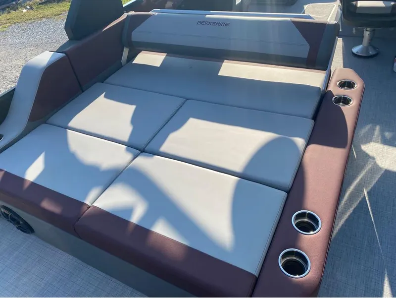 Slide: The Image of 2025 Berkshire 23UL STS boat interior with cushioned seating and cup holders. - 18