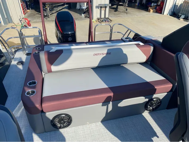 Slide: The Image of 2025 Berkshire 23UL STS boat interior with cushioned seating and cup holders. - 21