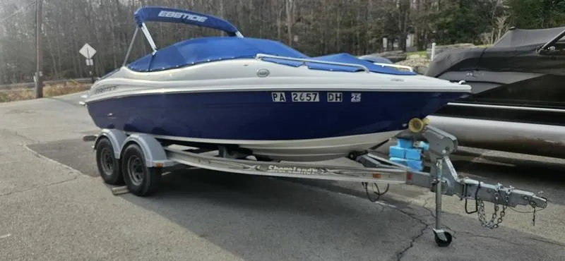 Slide: The Image of 2010 Ebbtide 202 SE Bow Rider boat on trailer, parked outdoors. - 0