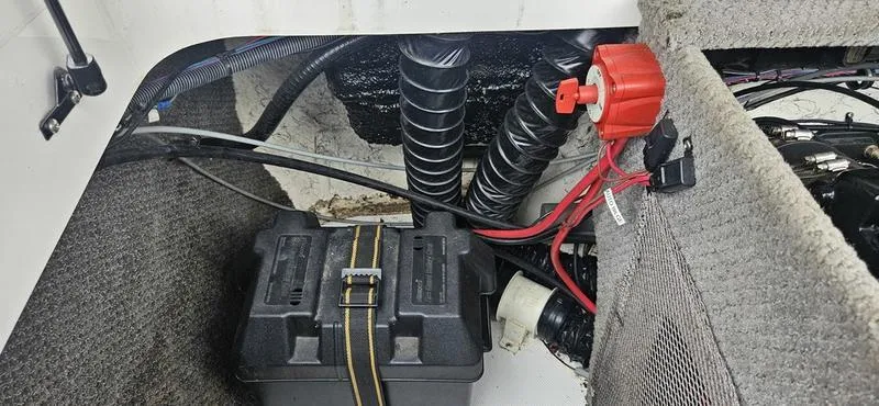 Slide: The Image of Battery compartment of 2010 Ebbtide 202 SE Bow Rider with wiring and red switch. - 4