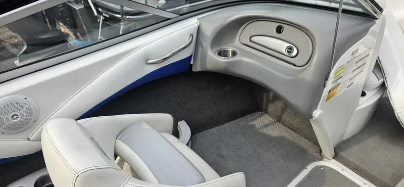 Slide: The Image of 2010 Ebbtide 202 SE Bow Rider interior with gray seating and carpeted floor. - 6