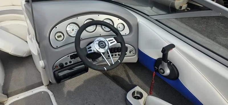 Slide: The Image of 2010 Ebbtide 202 SE Bow Rider dashboard with steering wheel and controls. - 7