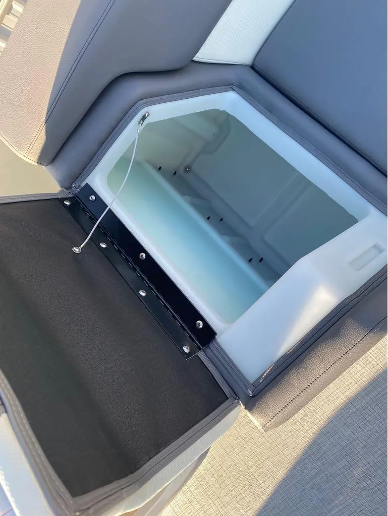 Slide: The Image of Open storage compartment in 2025 Berkshire 25RFX STS boat seat. - 13