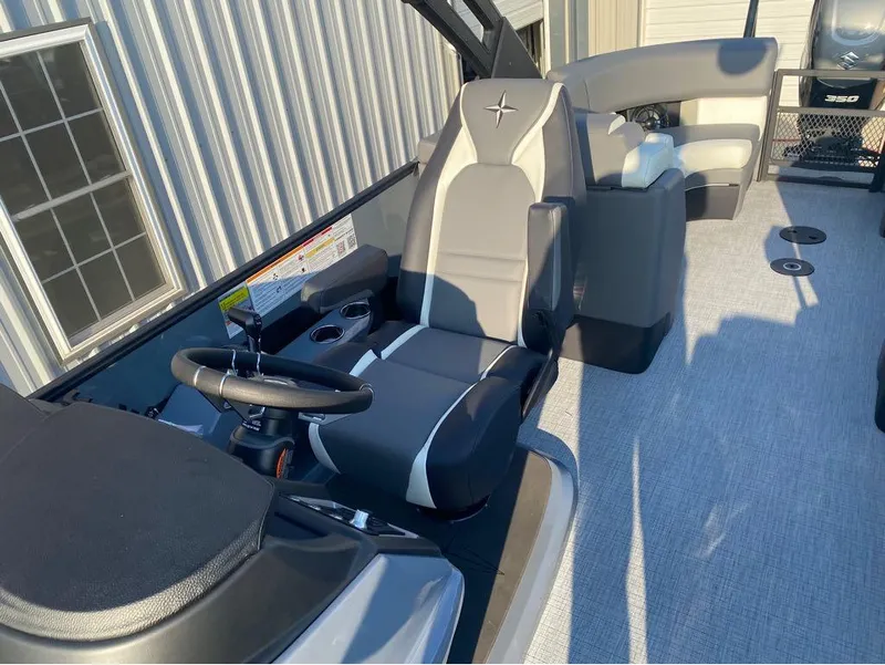 Slide: The Image of 2025 Berkshire 25RFX STS boat interior with captain's chair and steering wheel. - 14