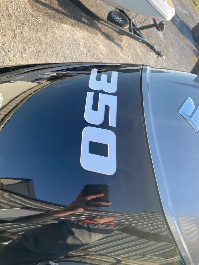 Slide: The Image of 2025 Berkshire 25RFX STS boat with "350" decal on black surface. - 2
