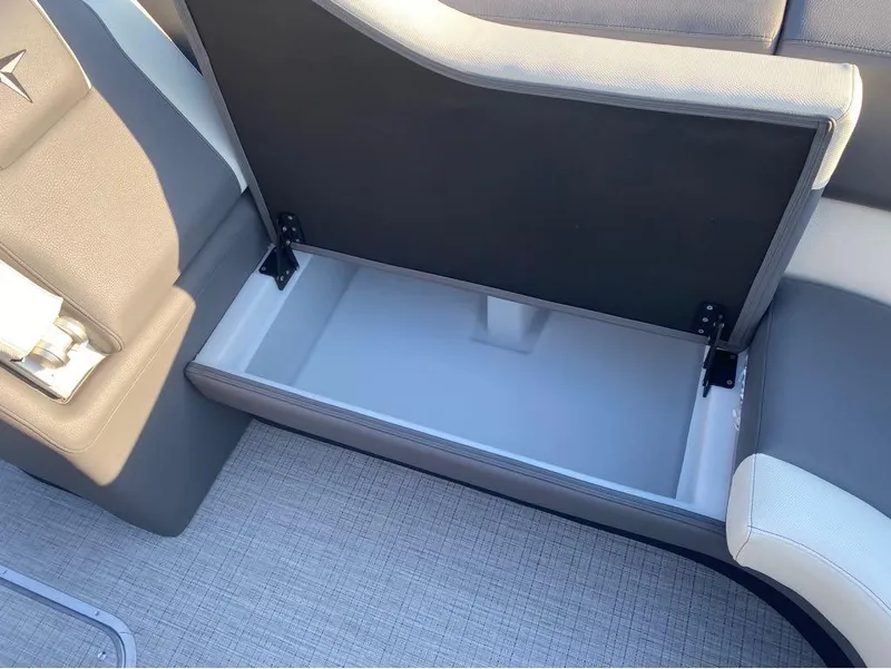 Slide: The Image of Open storage compartment in 2025 Berkshire 25RFX STS boat, featuring sleek seating design. - 25