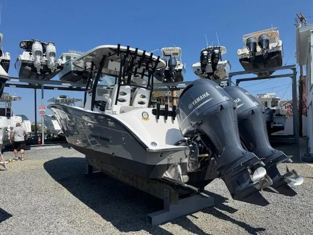 Slide: The Image of 2022 Cape Horn 27 XS boat with dual Yamaha engines in a marina storage area. - 11