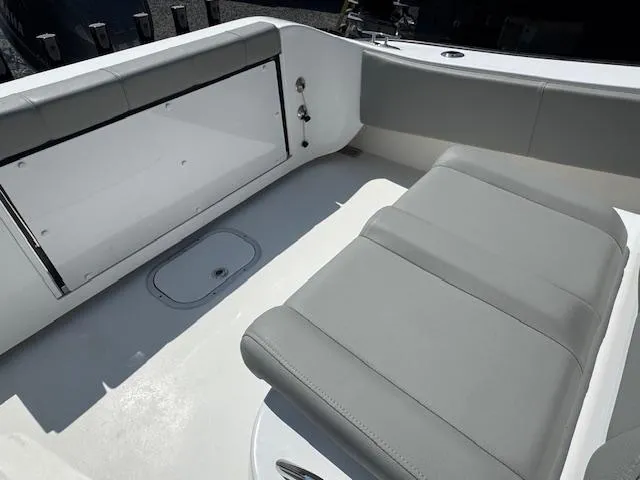 Slide: The Image of 2022 Cape Horn 27 XS boat interior with gray seating and storage compartment. - 4