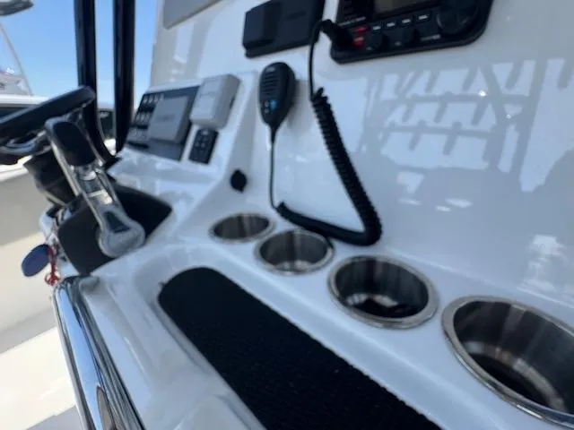 Slide: The Image of Control panel of 2022 Cape Horn 27 XS boat with cup holders and radio. - 5