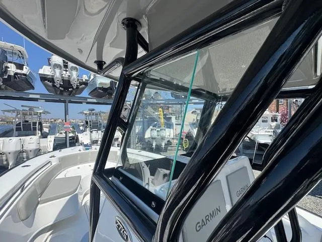 Slide: The Image of 2022 Cape Horn 27 XS boat interior with Garmin equipment, docked among other boats. - 9
