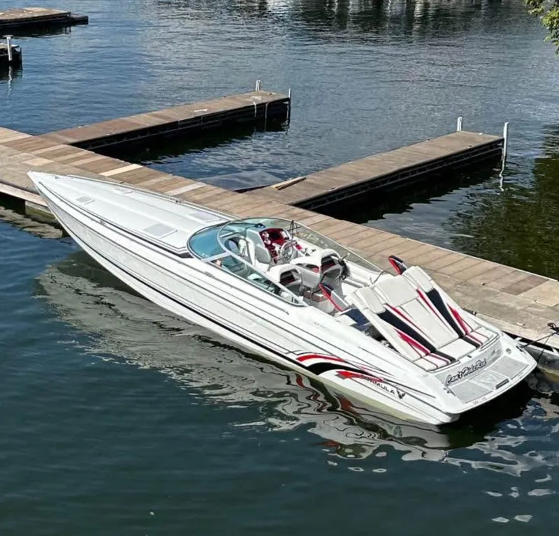 Slide: The Image of 2008 Formula 353 FASTech speedboat docked on calm water. - 0