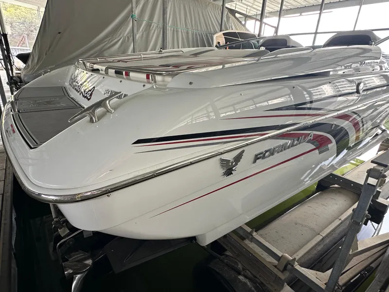 Slide: The Image of 2008 Formula 353 FASTech boat in storage, showcasing sleek design and vibrant graphics. - 11