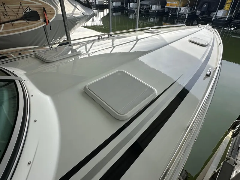 Slide: The Image of 2008 Formula 353 FASTech boat deck, sleek design, docked in marina. - 14