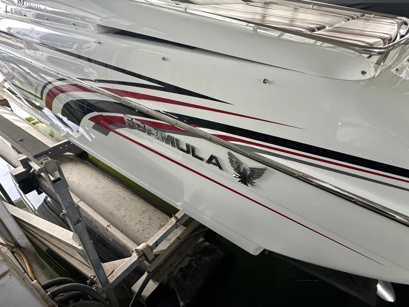 Slide: The Image of 2008 Formula 353 FASTech boat with sleek design and bold graphics on a trailer. - 18
