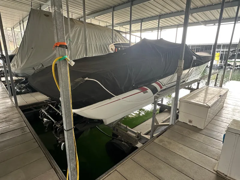 Slide: The Image of 2008 Formula 353 FASTech boat covered and docked in a marina. - 2