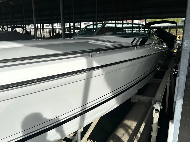 Slide: The Image of 2008 Formula 353 FASTech boat docked in a covered marina. - 24