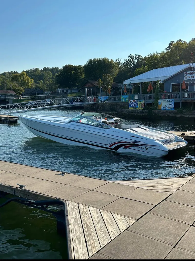 Slide: The Image of 2008 Formula 353 FASTech boat docked at a scenic lakeside marina. - 3