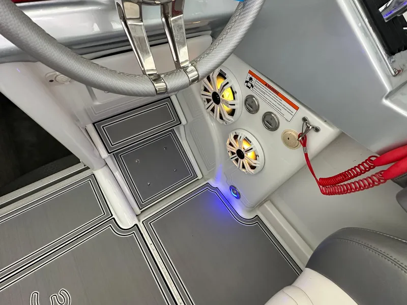 Slide: The Image of 2008 Formula 353 FASTech boat interior with steering wheel, speakers, and control panel. - 32