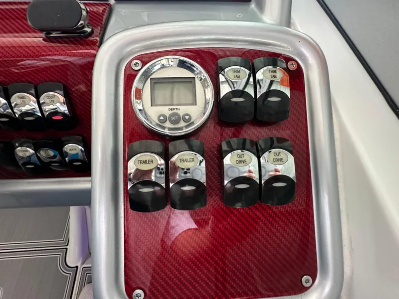 Slide: The Image of Control panel of a 2008 Formula 353 FASTech boat with switches and digital display. - 34