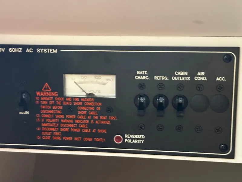 Slide: The Image of Control panel of a 2008 Formula 353 FASTech boat with warning labels and switches. - 41