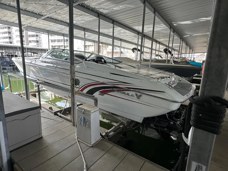 Slide: The Image of 2008 Formula 353 FASTech speedboat docked in a covered marina. - 5