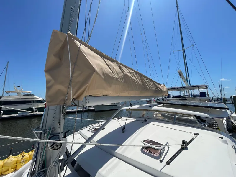 Slide: The Image of Leopard 40 catamaran, 2005 model, docked with covered sail, under clear blue sky. - 10