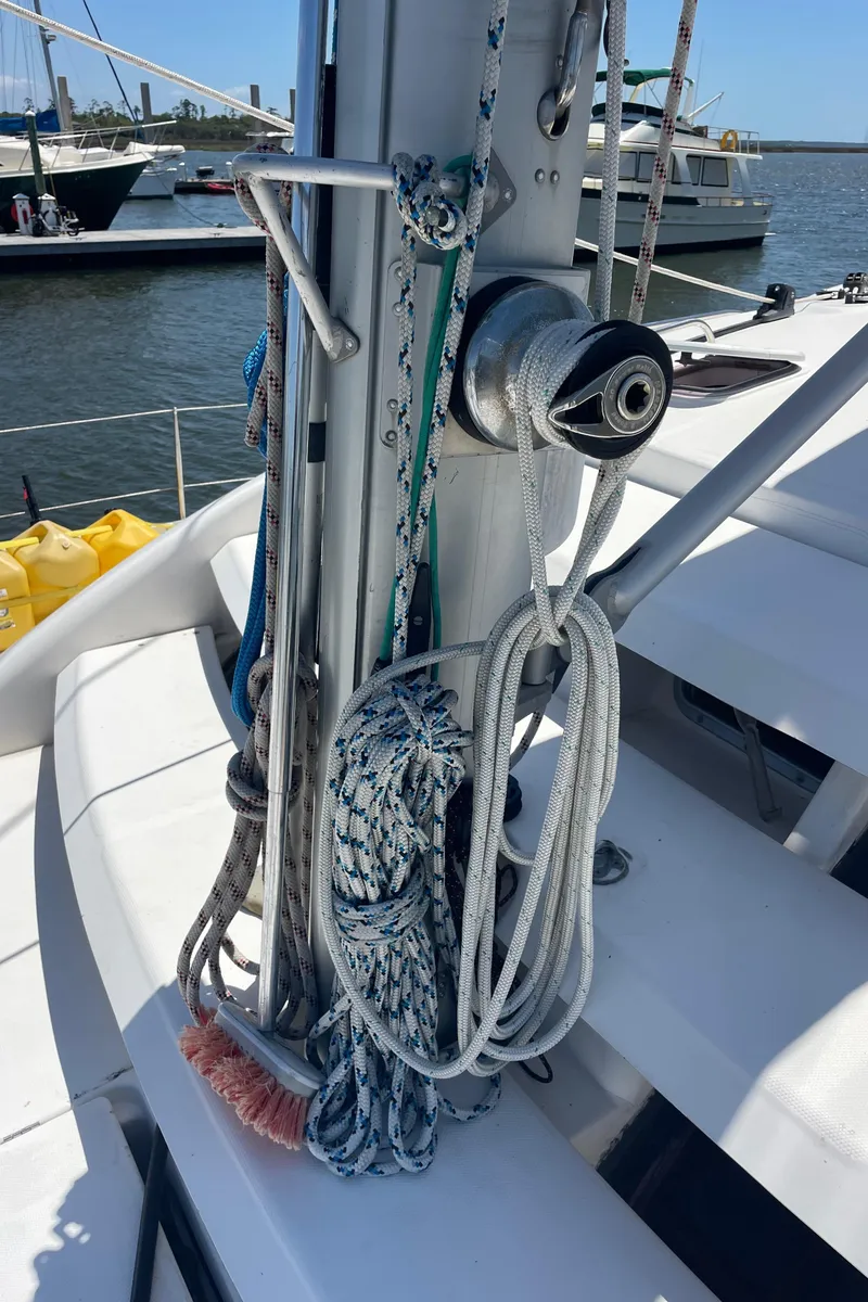 Slide: The Image of Sailing equipment on a 2005 Leopard 40 catamaran, docked at a marina. - 12