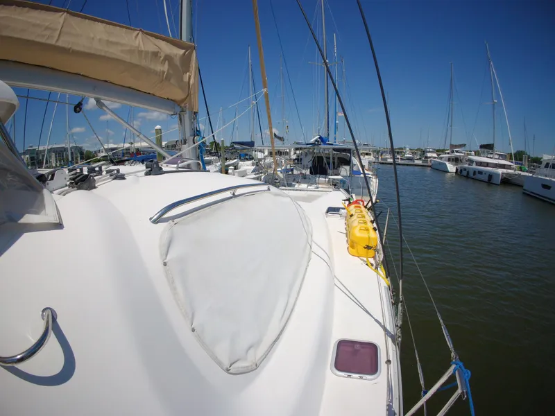 Slide: The Image of Sailboat Leopard 40, 2005 model, docked in a marina under clear blue skies. - 16