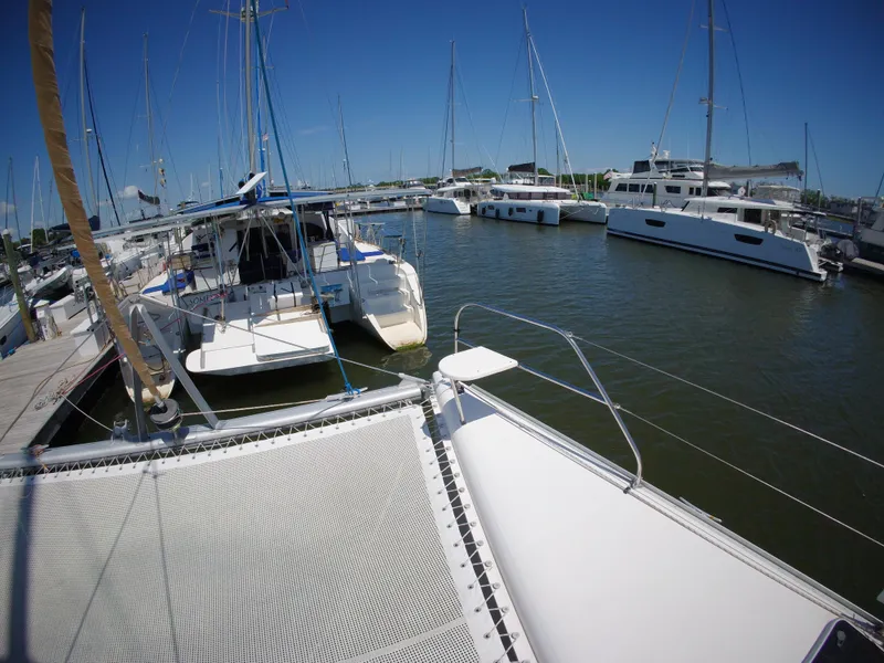 Slide: The Image of Docked Leopard 40 catamarans in a marina, clear blue sky, 2005 model. - 19