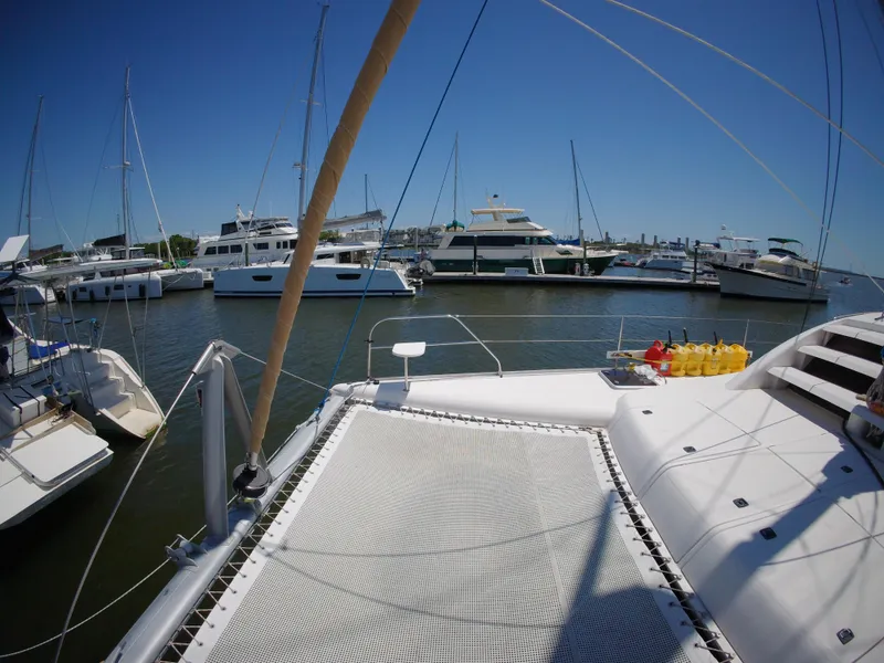 Slide: The Image of Catamaran docked in marina, Leopard 40 model, 2005, surrounded by other boats under clear blue sky. - 20