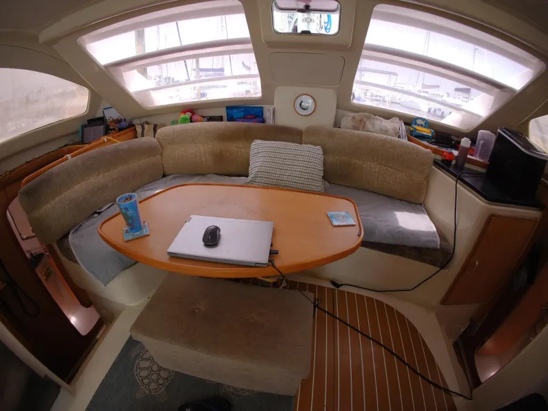Slide: The Image of Interior of a 2005 Leopard 40 catamaran with a cozy seating area and table. - 29