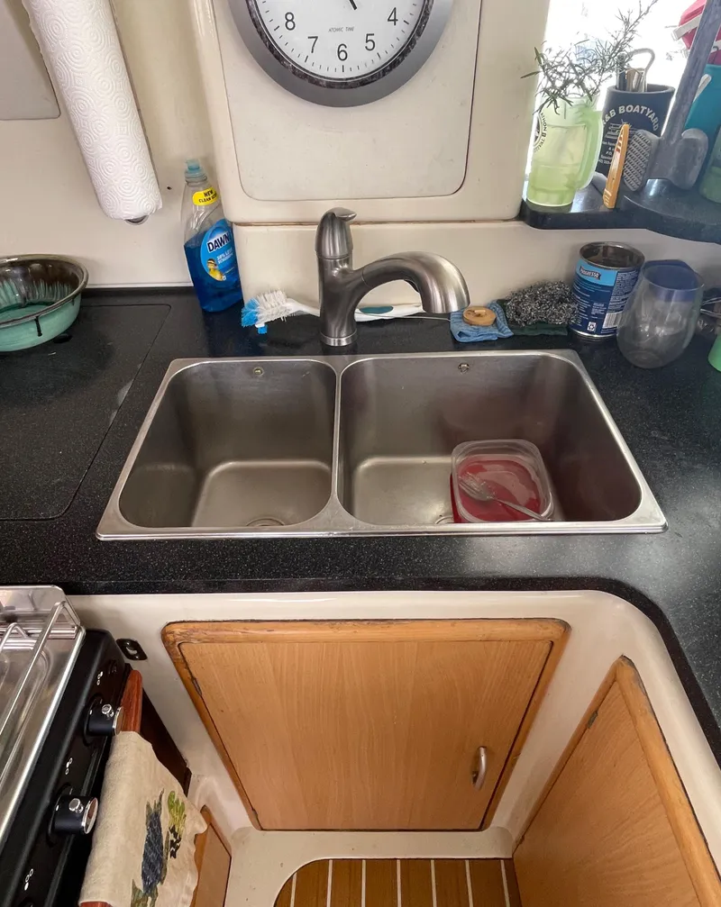 Slide: The Image of Kitchen sink area in a 2005 Leopard 40, featuring a double stainless steel sink. - 35