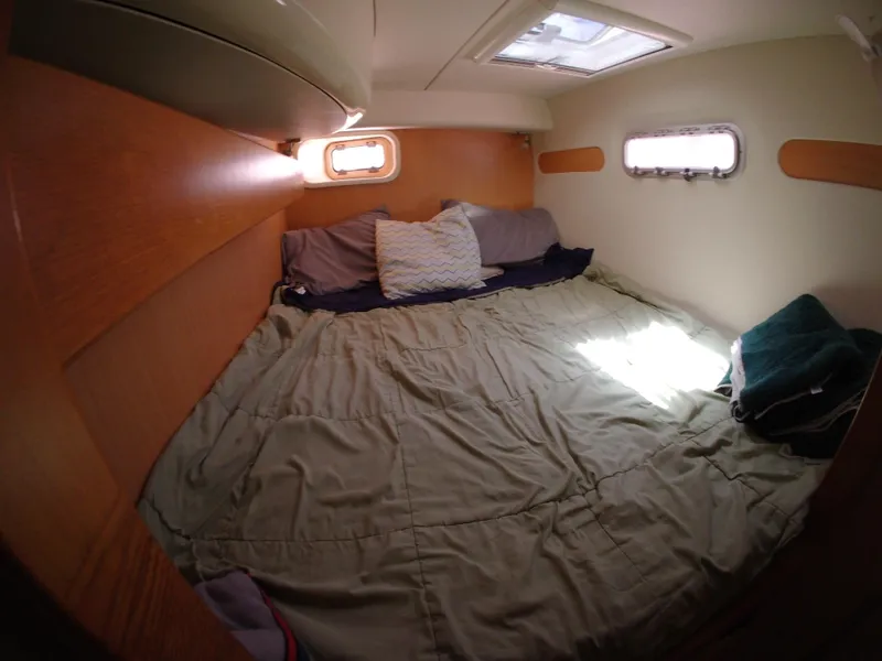 Slide: The Image of Cozy cabin interior of 2005 Leopard 40 catamaran with bed and porthole windows. - 39